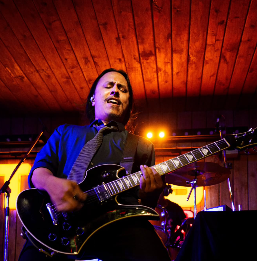 Singing and playing guitar at a live show